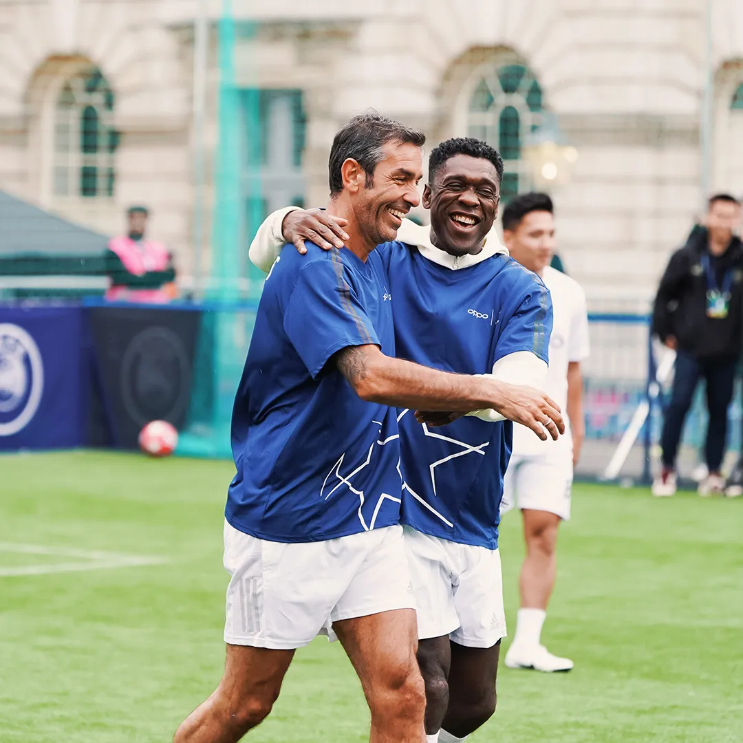 Former Football Stars Sharing a Joyful Moment on the Field