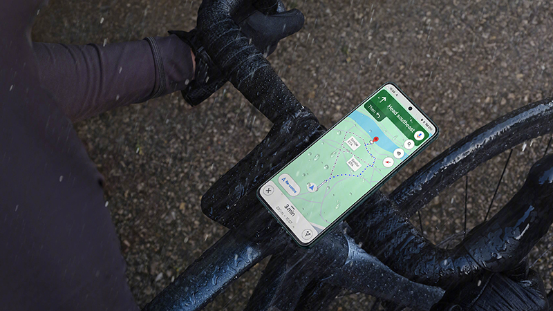 A cellphone on a bike handlebar Description automatically generated